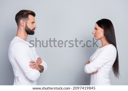 Photo of attractive confident sister brother wear white shirts hands crossed looking each other isolated grey color background Royalty-Free Stock Photo #2097419845