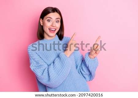 Portrait of attractive cute girly cheerful girl demonstrating ad advert copy space new novelty isolated over pink pastel color background