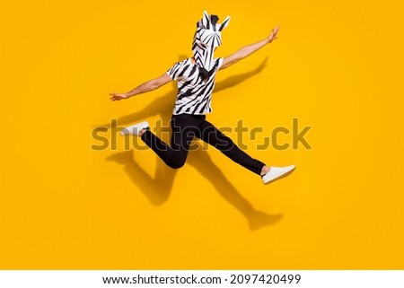 Photo of funny funky guy dressed wild animal costume jumping high arms sides isolated yellow color background
