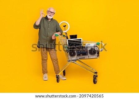Full length photo of positive handsome person show okey symbol benefit trade isolated on yellow color background