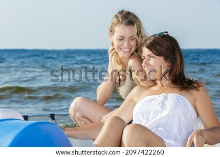 two young women on pedalo Royalty-Free Stock Photo #2097422260