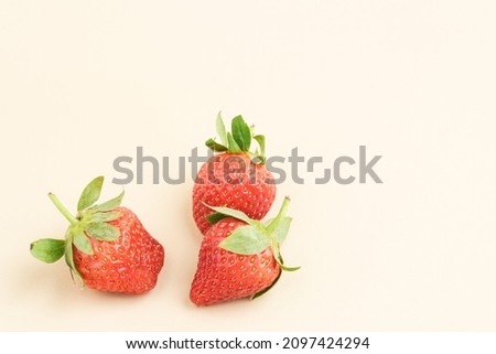 Strawberry, fresh juicy strawberries with leaves isolated on pink background. Close up and selective focus. Copy space.
