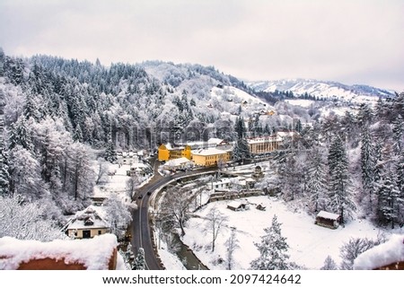 Aerial View Of A Spectacular Winter Snowy Landscape. Roadside Houses Covered In Snow. Transylvania, Romania. Travel Concept
