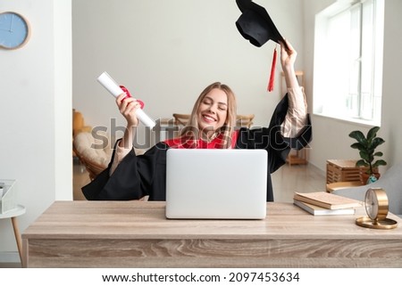 Happy female student on her graduation day at home. Concept of online education Royalty-Free Stock Photo #2097453634