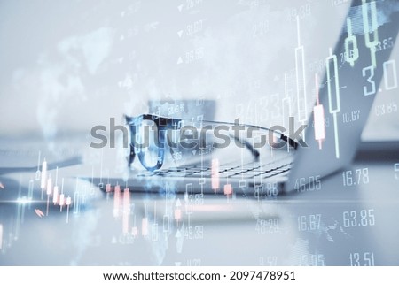 Close up of laptop and glasses with map, creative glowing big data forex chart candlestick hologram on blurry office background. Trade, technology and finance concept. Double exposure