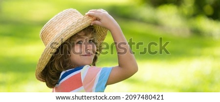 Banner with spring child face. Portrait of cheerful child in summer nature park. Cute joyful little boy kid. Close up portrait of funny little child boy in straw hat. Summer vacation.