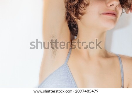 Armpit hair on a young teenager. Close-up shot of underarm hair on young body of Caucasian girl. hairy armpits teen