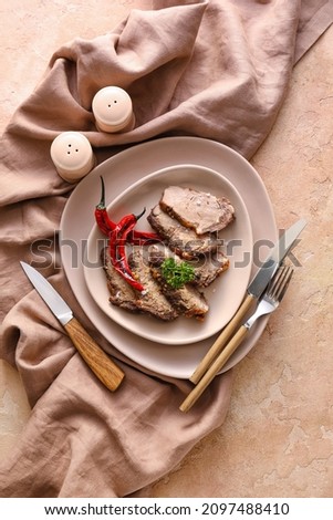 Plate with tasty beef brisket on color background