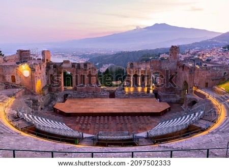 Sunset on the ancient roman-greek amphitheater with the Giardini Naxos bay in the back in Taormina, Sicily, Italy Royalty-Free Stock Photo #2097502333