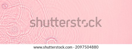 Abstract summer banner background Transparent pink clear water surface texture with ripples, splashes and bubbles. Water waves in sunlight with copy space Cosmetics moisturizer micellar toner emulsion Royalty-Free Stock Photo #2097504880