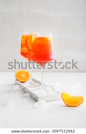 Glasses of Aperol spritz cocktail on light background Royalty-Free Stock Photo #2097512962