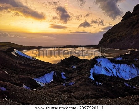 An ice pond on iceberg in Iceland. When sunlight hits to ice surface, reflected shown a beautiful scenery.