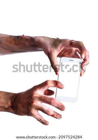 Hands of zombie with mobile phone on white background