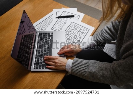 Woman designer create website design wireframe. Sketch, prototype, framework, layout future design project. UI and UX - user interface, user experience designer. Creative concept for web design studio Royalty-Free Stock Photo #2097524731