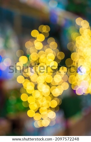 Abstract bokeh lights with soft light background. Festive abstract christmas texture, golden bokeh particles and highlights on dark background.Blue and pink bokeh abstract in blurred background.