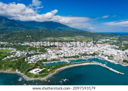 Aerial view of Taiwan harbor, shore and coastline. Bird eye of shore, wave, cloud, coastline,  white house and mountain in Chenggong harbor nearby Sanxiantai, Chenggong Township, Taitung country Royalty-Free Stock Photo #2097593179