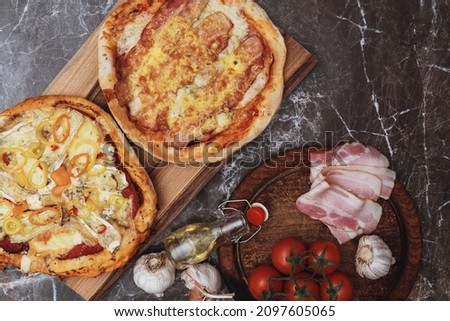 Different types of pizza.  Cheese pizza, cold cuts pizza, pizza bacon, ham, salami