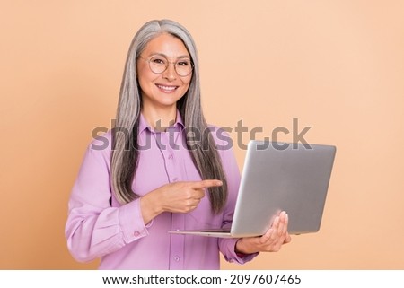 Photo of hr grey hairdo elder lady index laptop wear eyewear purple shirt isolated on beige background