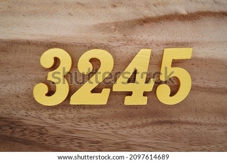 Golden Arabic numerals 3245 on a dark brown to white wood grain background.