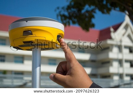 Finger press button of GNSS RTK receiver engine.For GPS point survey engineering or route surveying.Civil or technician method  technology concept.Equipment tools.View of copy space.