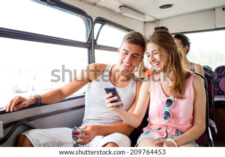 friendship, summer vacation, transport, technology and people concept - smiling couple with smartphone traveling by bus and making selfie Royalty-Free Stock Photo #209764453
