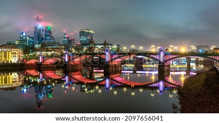 Southwark bridge and financial district of London at night. England
