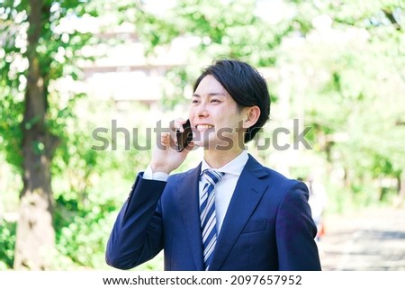 Asian young businessman calling outdoor