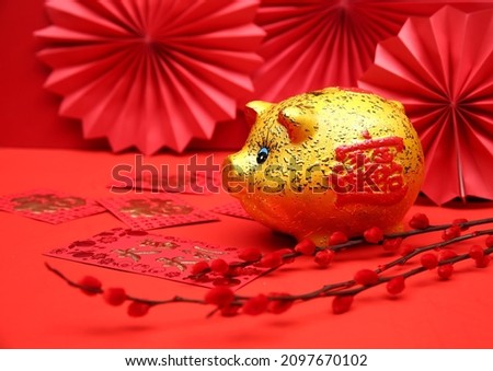 Golden piggy bank with red background,calligraphy translation: good bless for saving and wealth.  Chinese Language on envelop mean Happiness
