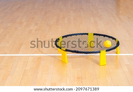 Spike ball game with yellow ball on hardwood court floor. Horizontal sport theme poster, greeting cards, headers, website and app