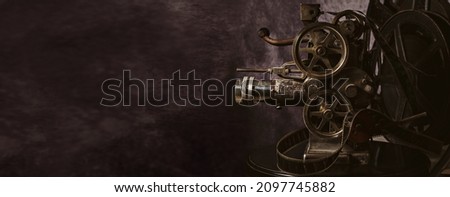 Vintage cinema projector on neutral background with copy space
