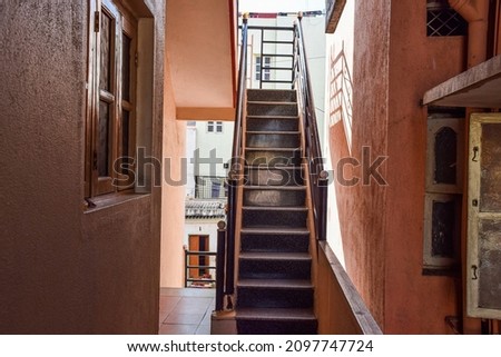 Stock photo of empty inside staircase in the residencial building, black color painted grill on both side of the stairs . Picture captured during day time at Bangalore, Karnataka, India.