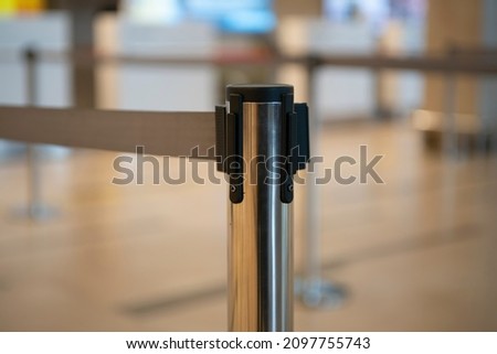 Fence rack with pulling tape at the airport. Barrier racks to delimit passengers in line. Royalty-Free Stock Photo #2097755743