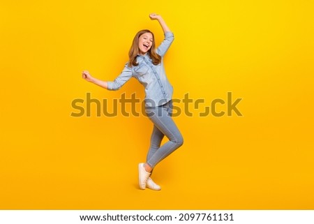 Full body photo of pretty teen blond girl dance wear jeans shirt footwear isolated on yellow color background