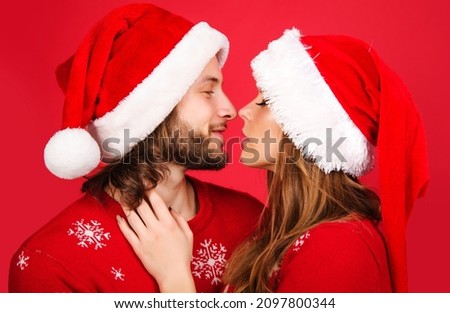 New Year couple in Christmas hat hugging and kissing. Romantic Relationships. Love concept.