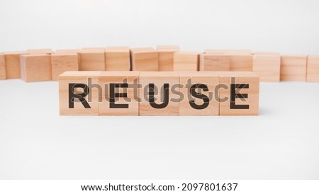 Reuse word, text, written on wooden cubes, building blocks, over white background.