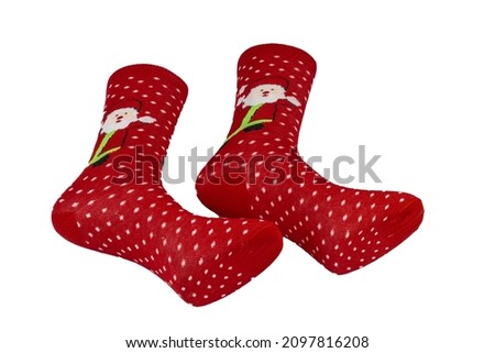 Woolen socks with a Christmas pattern, ornaments and decorations lie on a white background. Christmas and new year holiday concept,