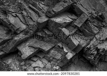 Texture, background layers and cracks in sedimentary rock on cliff face. Cliff of rock mountain. Rock slate in the mountain. Seamless abstract background. Cracks and layers of sandstone.
 Royalty-Free Stock Photo #2097830281