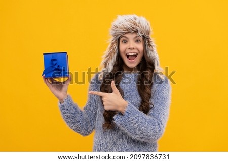 boxing day. teen girl in knitwear on yellow background. child buy gift. black friday discount.