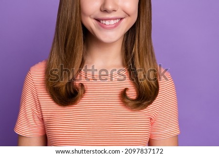 Cropped view portrait of attractive cheerful brown-haired girl healthy beaming smile isolated over bright violet purple color background