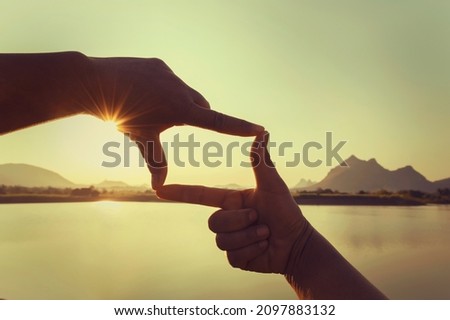 close up hand framing looking view sunrise