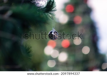 close up of silber ball ornament decorate on chistmas tree with blurred bokeh background