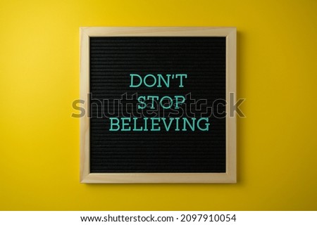 Motivational text word don't stop believing 