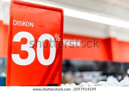 30% discount on clothing prices at the mall with a red banner background