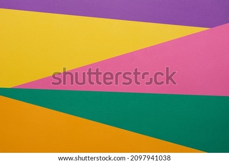 Different multicolored backgrounds. Layered color papers, color paper materials for the banner. Geometric pattern in green, light green, purple, yellow, blue, pink, light blue. Top view. Flat lay sty