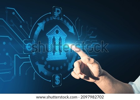 Close up of businessman hand pointing at abstract glowing online banking hologram. E-commerce, technology and innovation concept