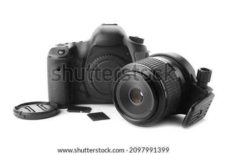 Digital camera, lens and memory cards on white background