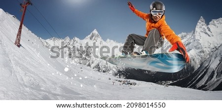 Snowboarder jumping through air with deep blue sky in background. Winter sport background.  Royalty-Free Stock Photo #2098014550