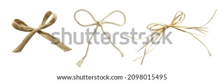 Set of beige canvas, rope and raffia bows isolated on white. Natural decorations.  Royalty-Free Stock Photo #2098015495