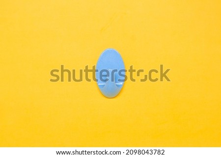 A Blue Wall Hanger in The Yellow Background