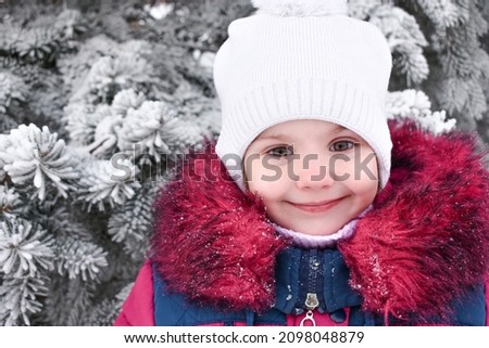  cute little girl smiling. winter. outside. High quality photo